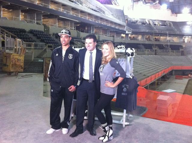 Darren Rovell at the Barclays Center with models